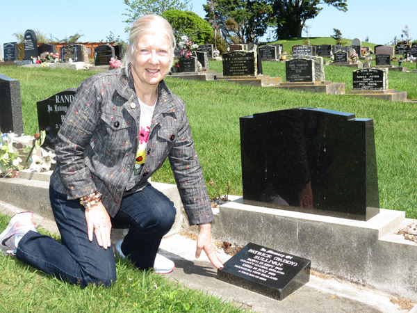 Geraldene O'Reilly at the grave of Paddy Sullivan at the Otaki Cemetery